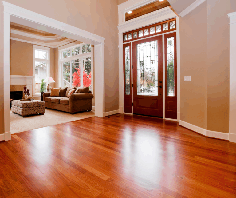 Spacious living room featuring hardwood floors and a front entrance with a decorative glass door