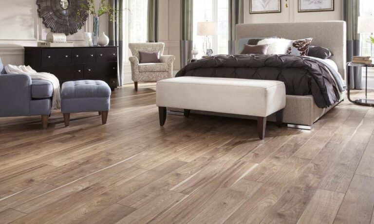 Cozy bedroom featuring a stylish bed, elegant furniture, and wooden flooring.